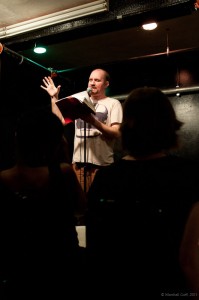 Adam Stone reads from one of his approximately 1,000,000 notebooks. Photo by Marshall Goff. Adam Stone reads from one of his approximately 1,000,000 notebooks. Photo by Marshall Goff.
