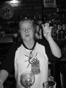 Judy Griffin behind the bar around 2007. (Judy's shirt is from the 1999 National Poetry Slam.) Photo by Caroline Harvey.