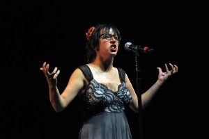 Sarah Brickman showcasing on the 2013 National Poetry Slam Finals stage. Photo by Arthur Pollock of the Boston Herald.