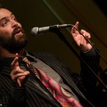 Andrew Campana takes the stage as the featured poet on October 15, 2014. Photo by Rich Beaubien.