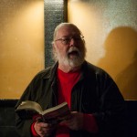 Michael Brown, founding SlamMaster, reads his own work from the Cantab anthology. Photo by Marshall Goff.