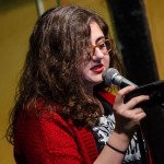 Jess Riz, pizza pi press curator, reads during the open mic. Photo by Rich Beaubien.