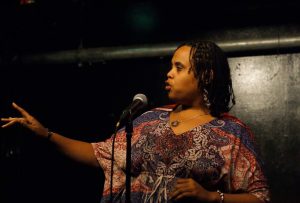 Vernell Bristow competes downstairs at the Cantab Lounge during the 2013 National Poetry Slam. Photo by Mark Skrzypczak.